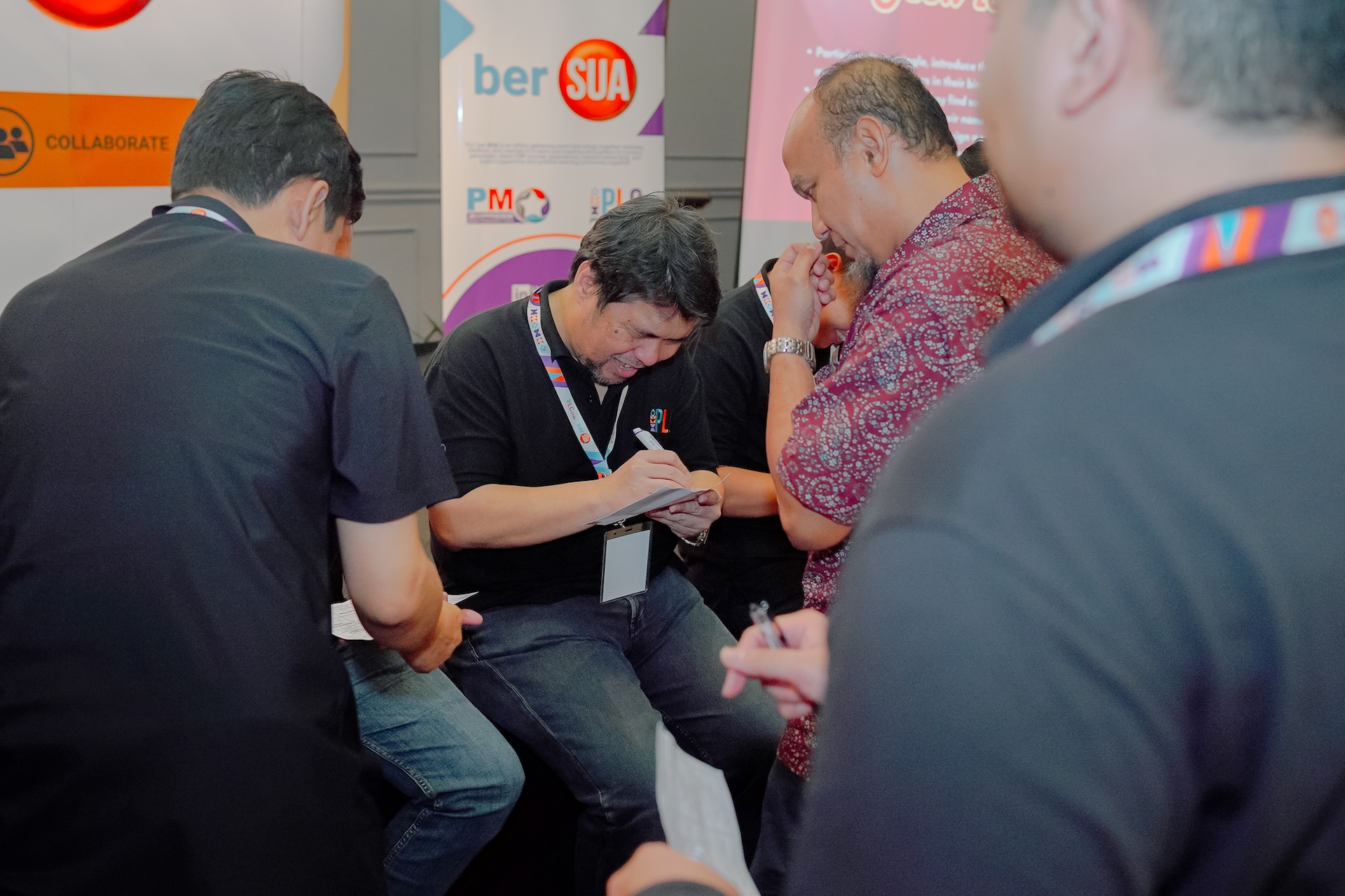 A snapshot of a PLC Indonesia class with a mentor walking through a PMP question